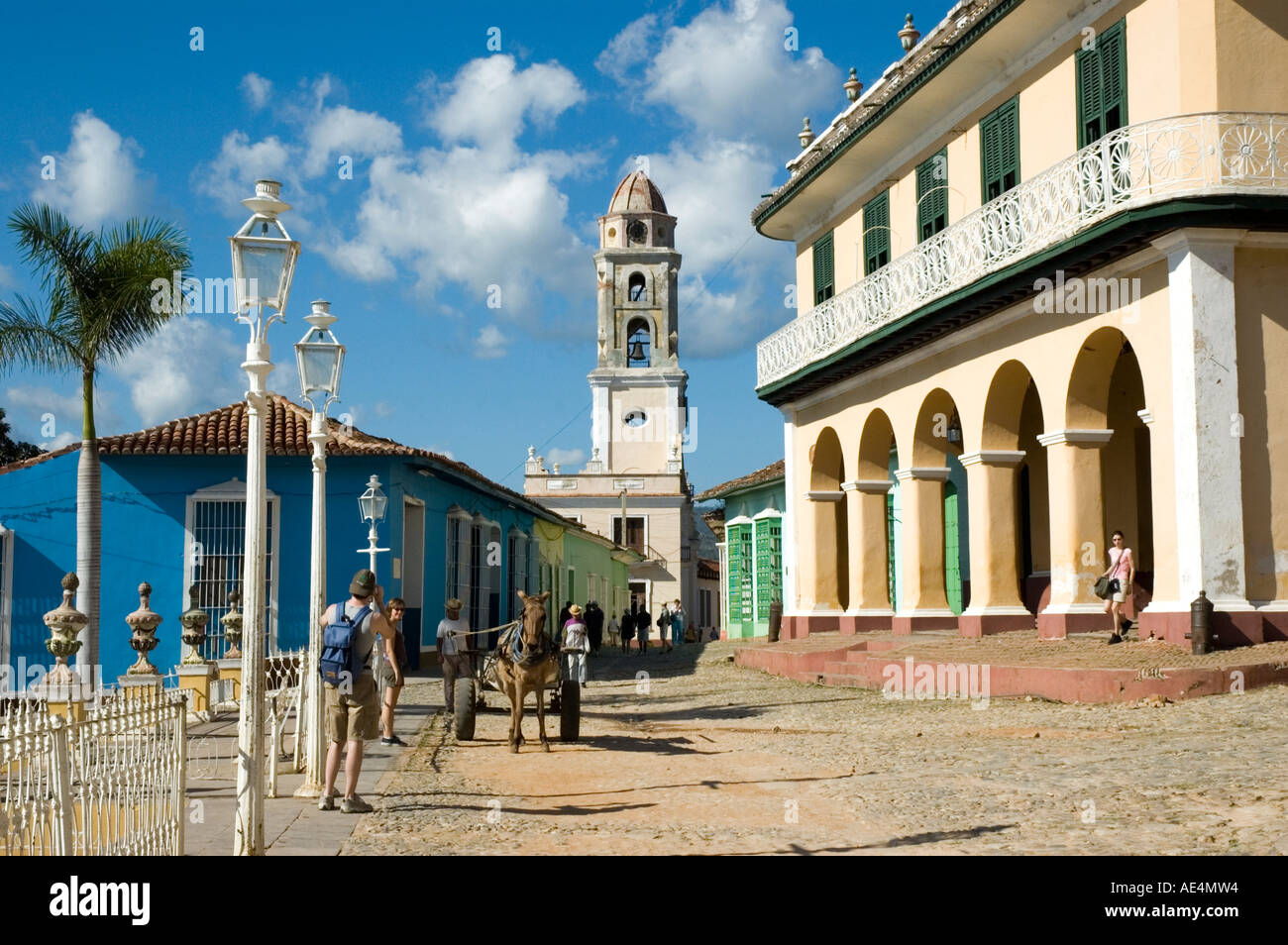 A horse and cart pose for a tourist by the Brunet Palace with the bell tower of the Church and Monastery of Saint Francis behind Stock Photo