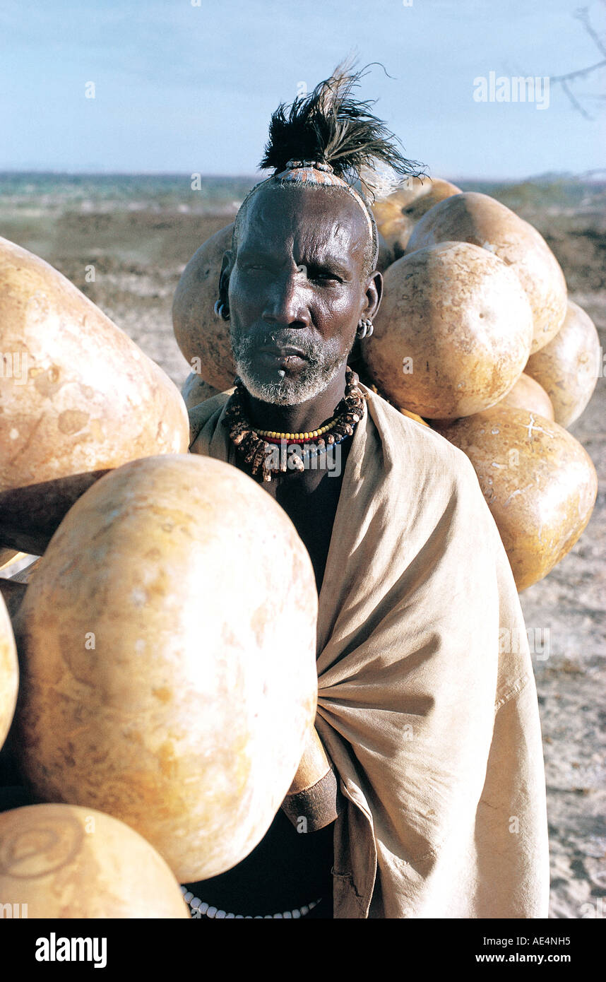 Turkana man carrying gourds to be used as water carriers Near Lodwar northern Kenya East Africa Stock Photo