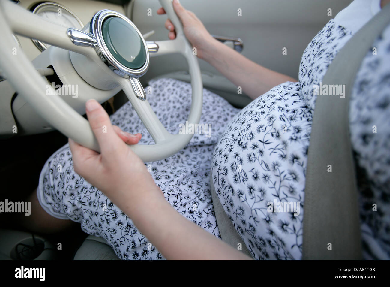 Pregnant woman driving Stock Photo