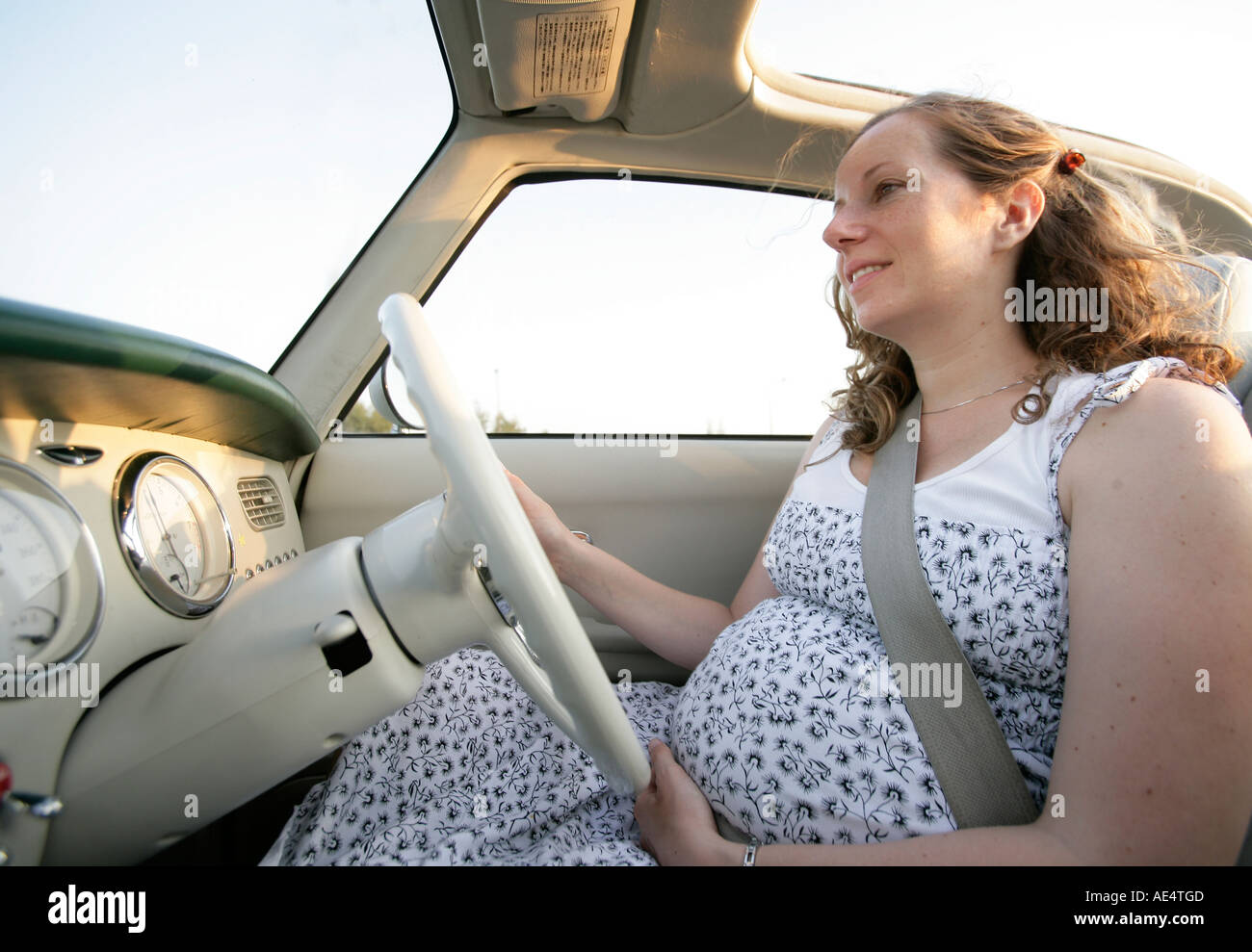 Pregnant woman driving Stock Photo