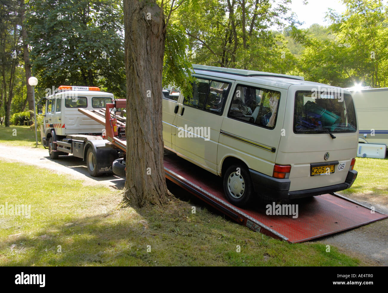 a VW campercan from the UK being rescued on a camping site in France by Europ Assistance Stock Photo