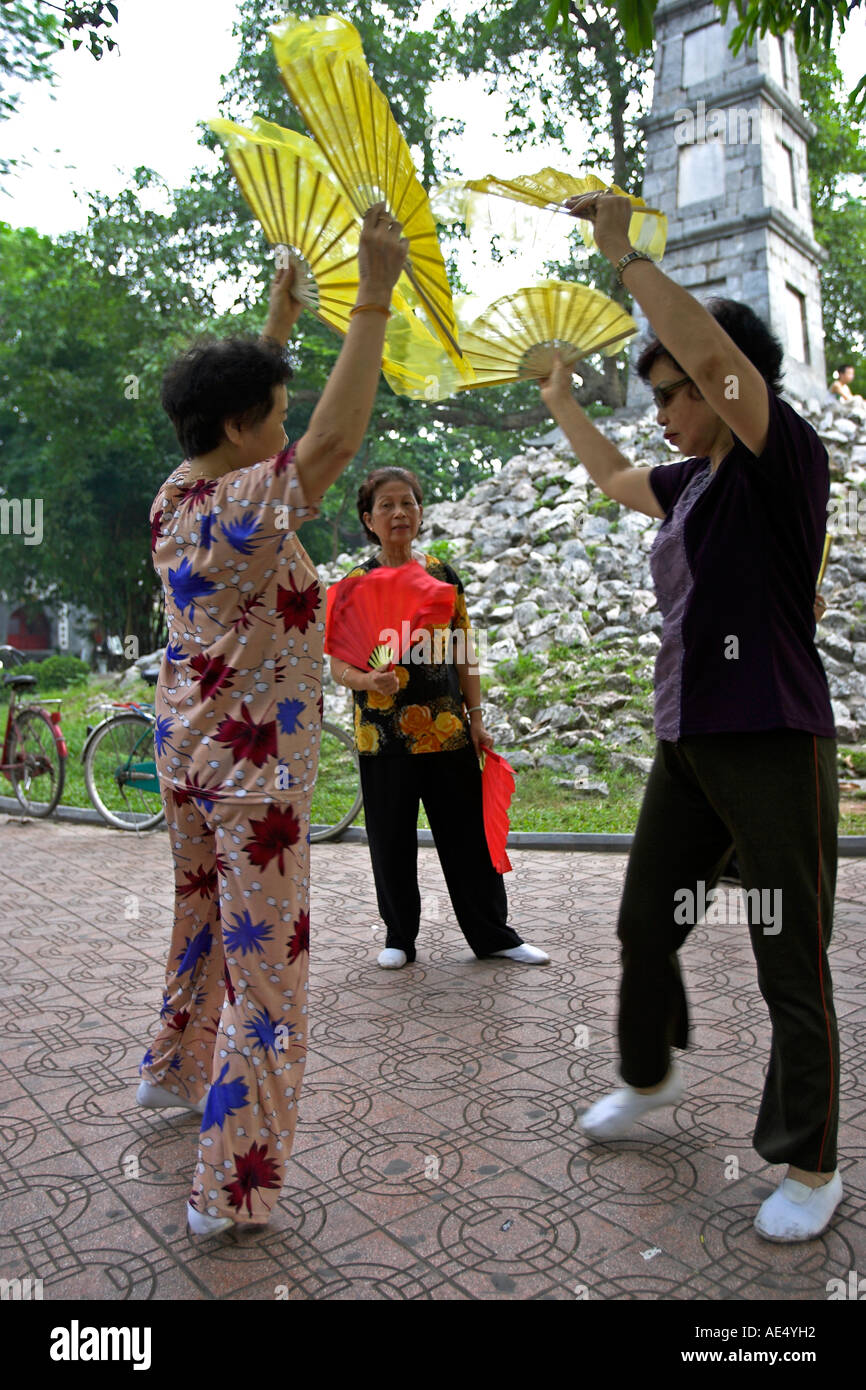 Older women practise fan dance steps entrance to Ngoc Son Temple at