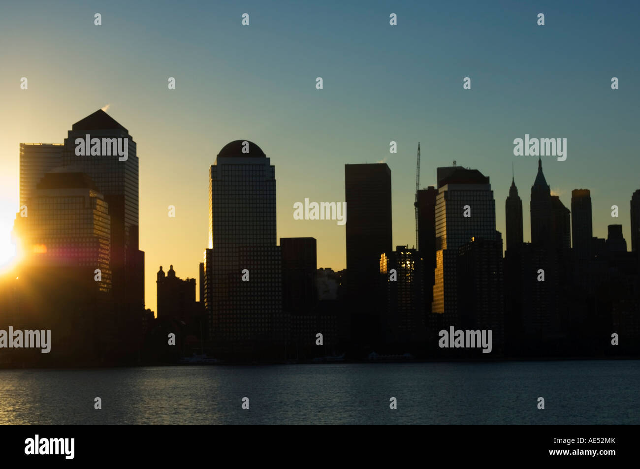 Lower Manhattan skyline at sunrise across the Hudson River, New York ...