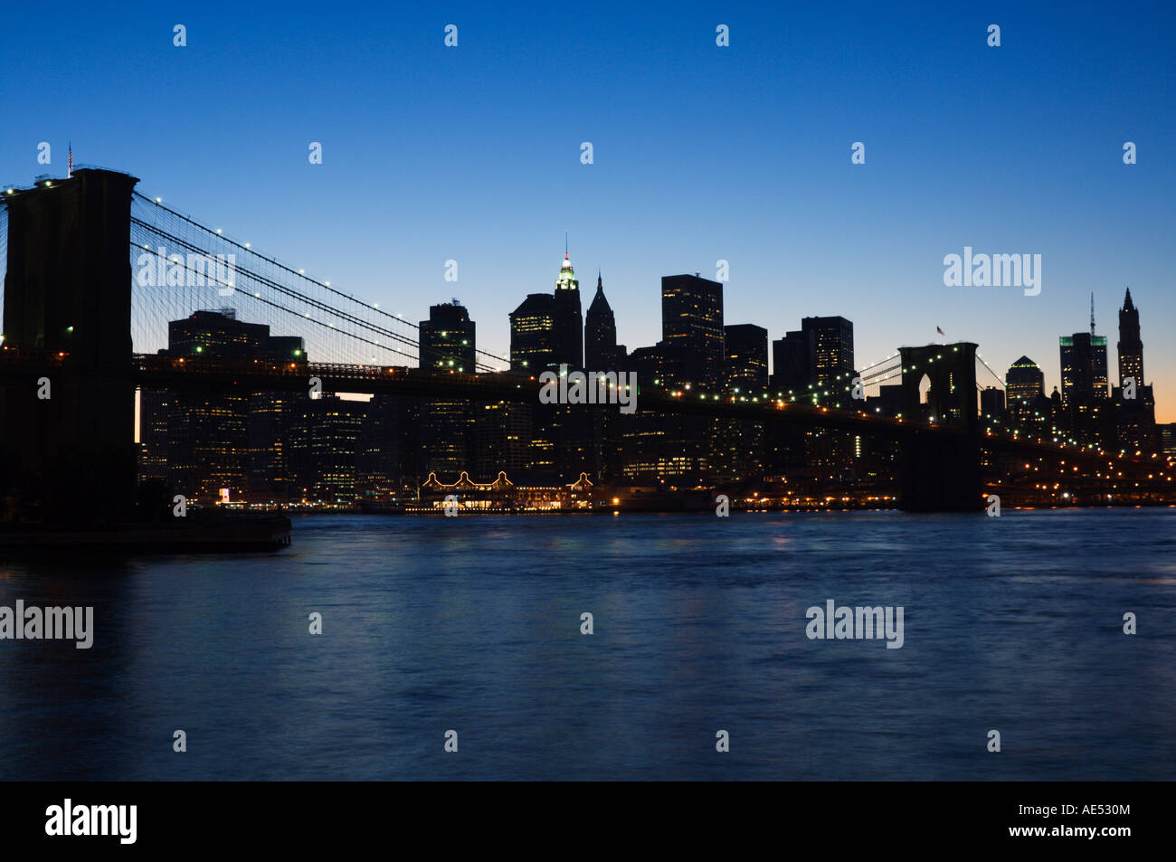 Manhattan skyline and Brooklyn Bridge at dusk, New York City, New York ...