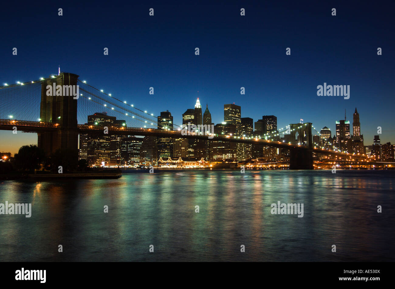 Manhattan skyline and Brooklyn Bridge at dusk, New York City, New York ...