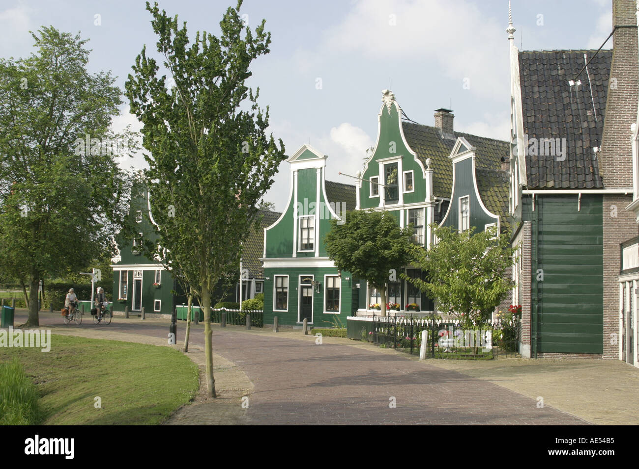 Cyclists enjoying a ride through the holiday village of Zaandam near Amsterdam in the province of Zaanstad,North Holland. Stock Photo