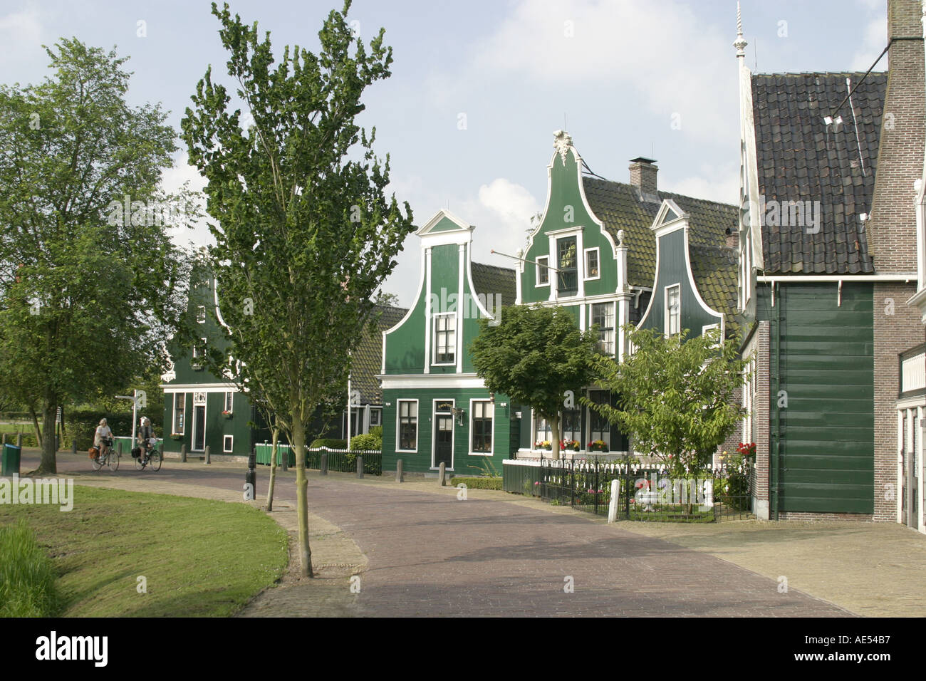 Cyclists enjoying a ride through the holiday village of Zaandam near Amsterdam in the province of Zaanstad,North Holland. Stock Photo