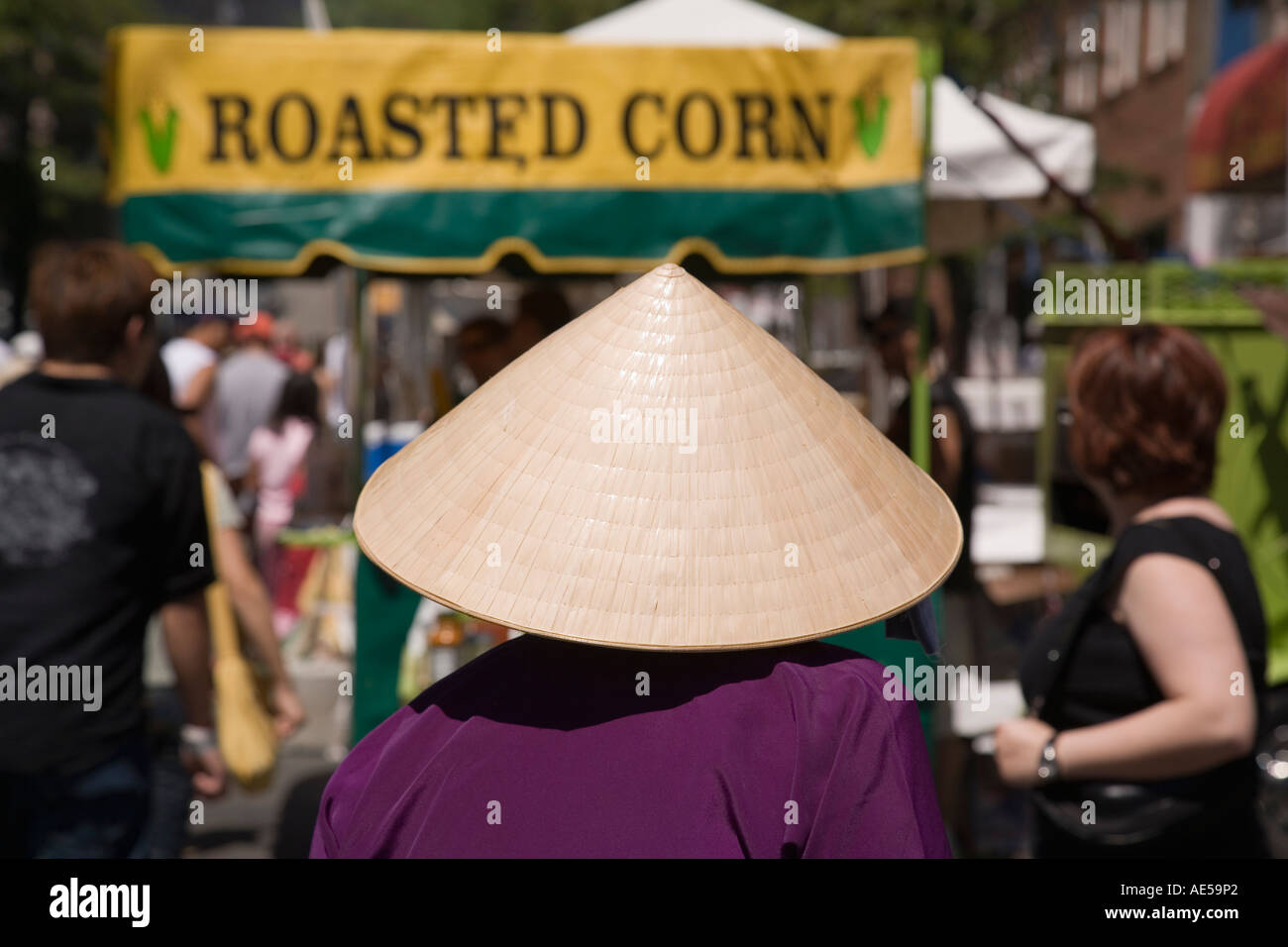 Woman wearing straw peasant hat at the International District Chinatown