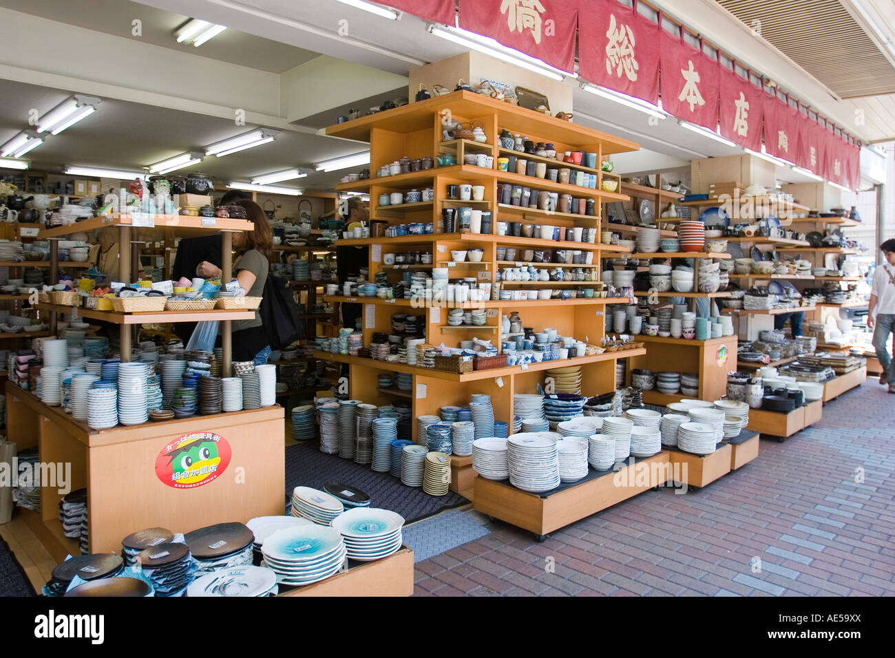 Front of a pottery store selling ceramic plates bowls cups and other tableware Stock Photo