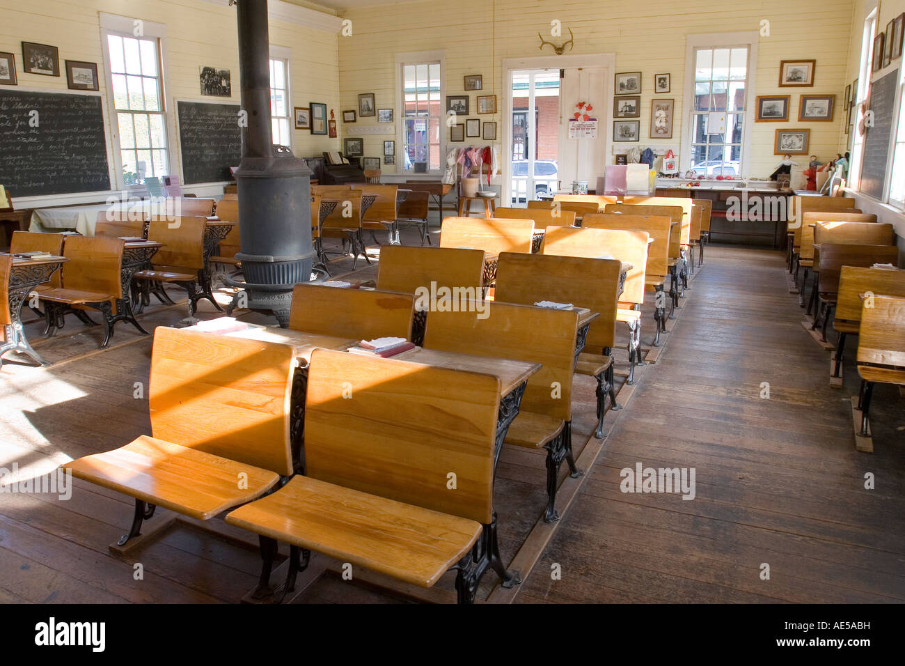 Classroom in replica of 1800s era one room schoolhouse with childrens desks chalkboards and wood stove Old Town Sacramento Stock Photo