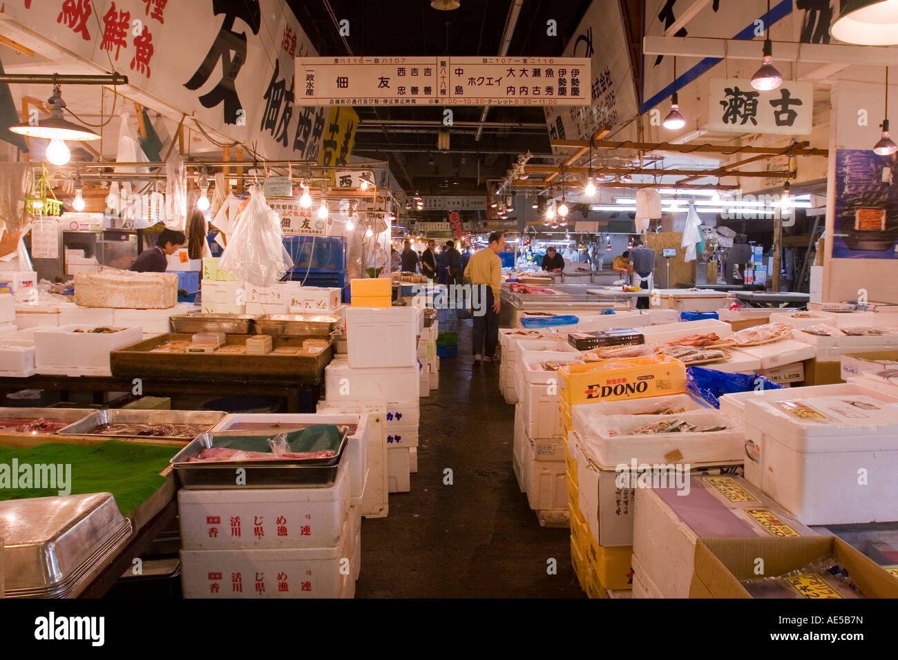 Narrow aisle through stalls selling fish at the Tsukiji Fish Market in