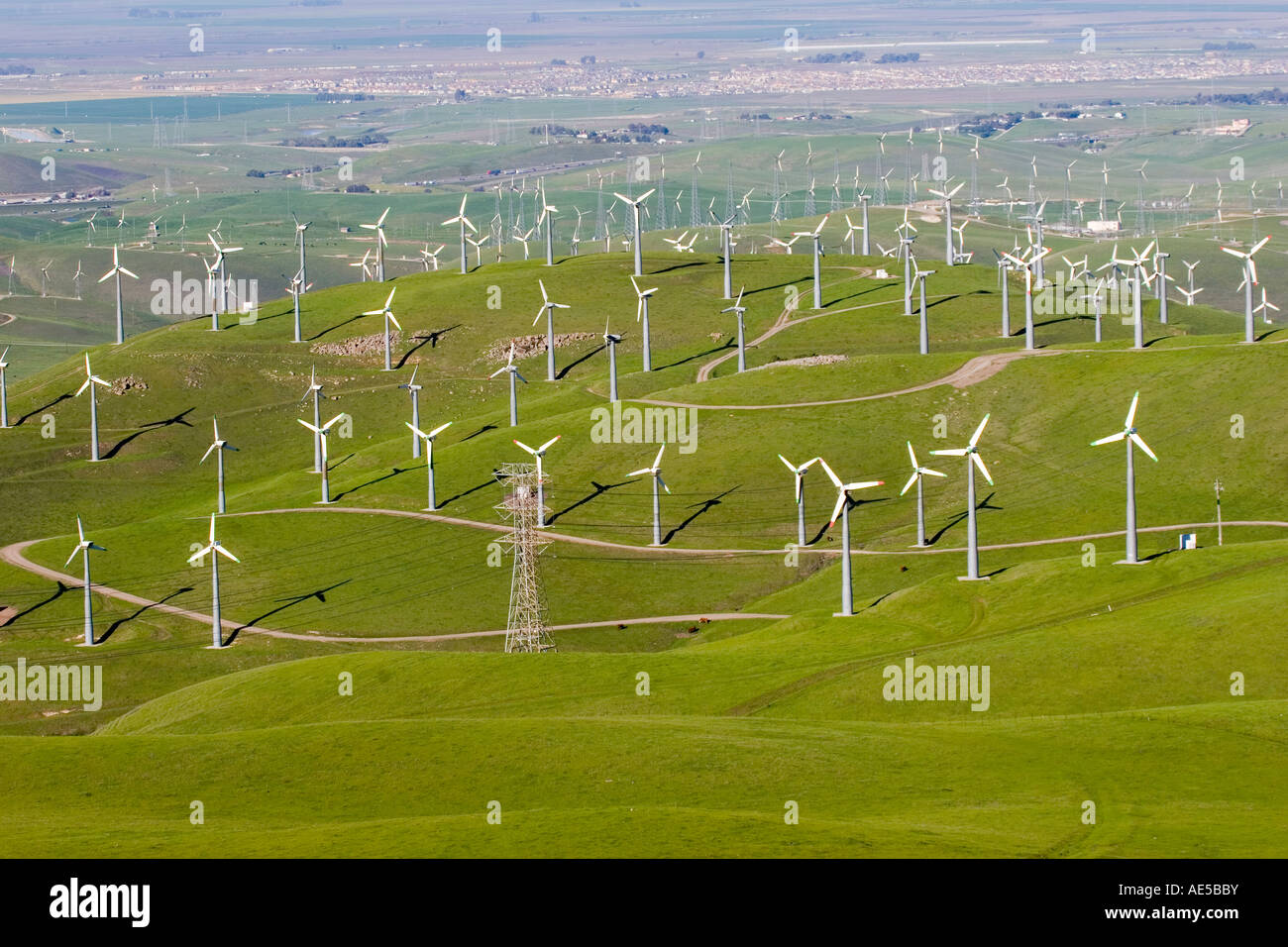 Many windmills in a large hilly field overlooking the town of Livermore California Stock Photo