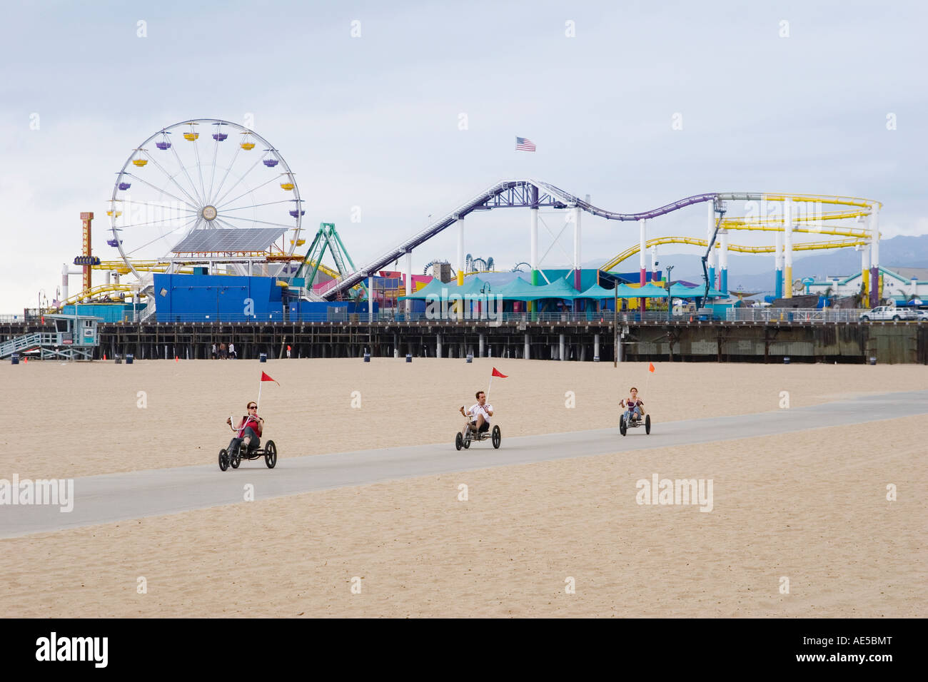 Tourists riding on beach in recumbent tricycles at Santa Monica Pier