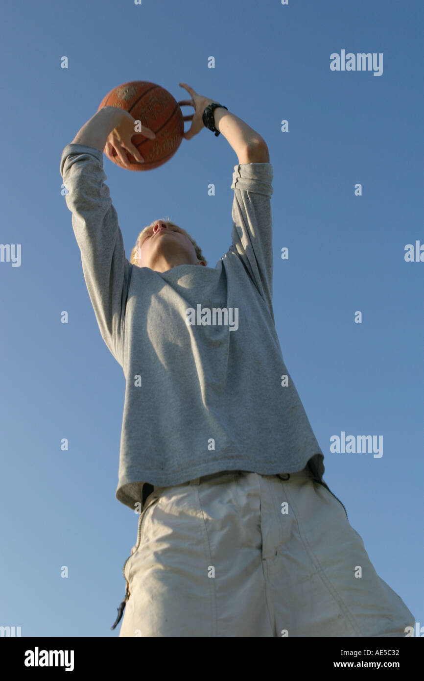 Boy Shooting Baskets Stock Photo Alamy