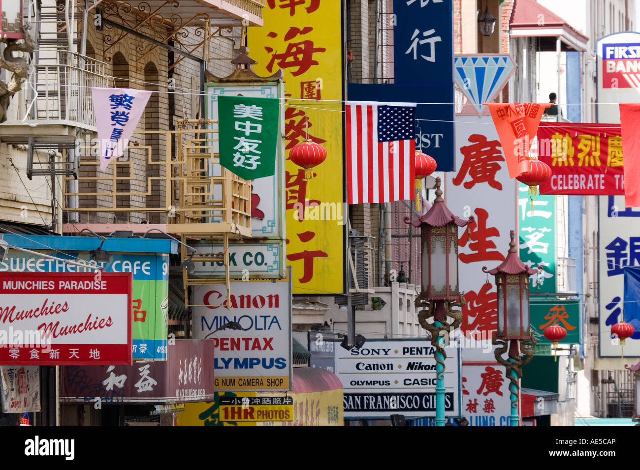 Visual cacophony of flags signs and banners in Chinese and English letters on busy street in San Francisco Chinatown Stock Photo