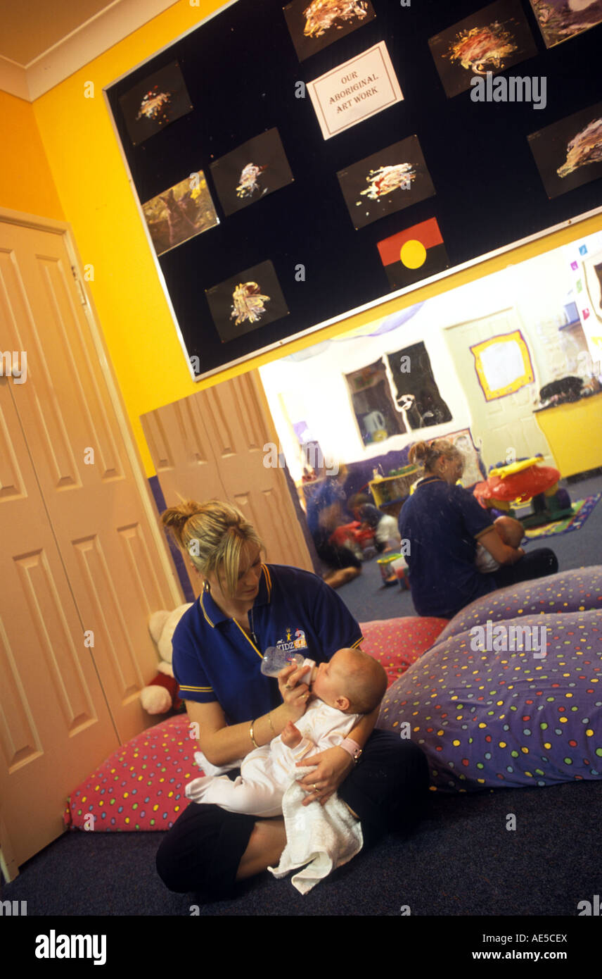 FEEDING infant at a day center Stock Photo