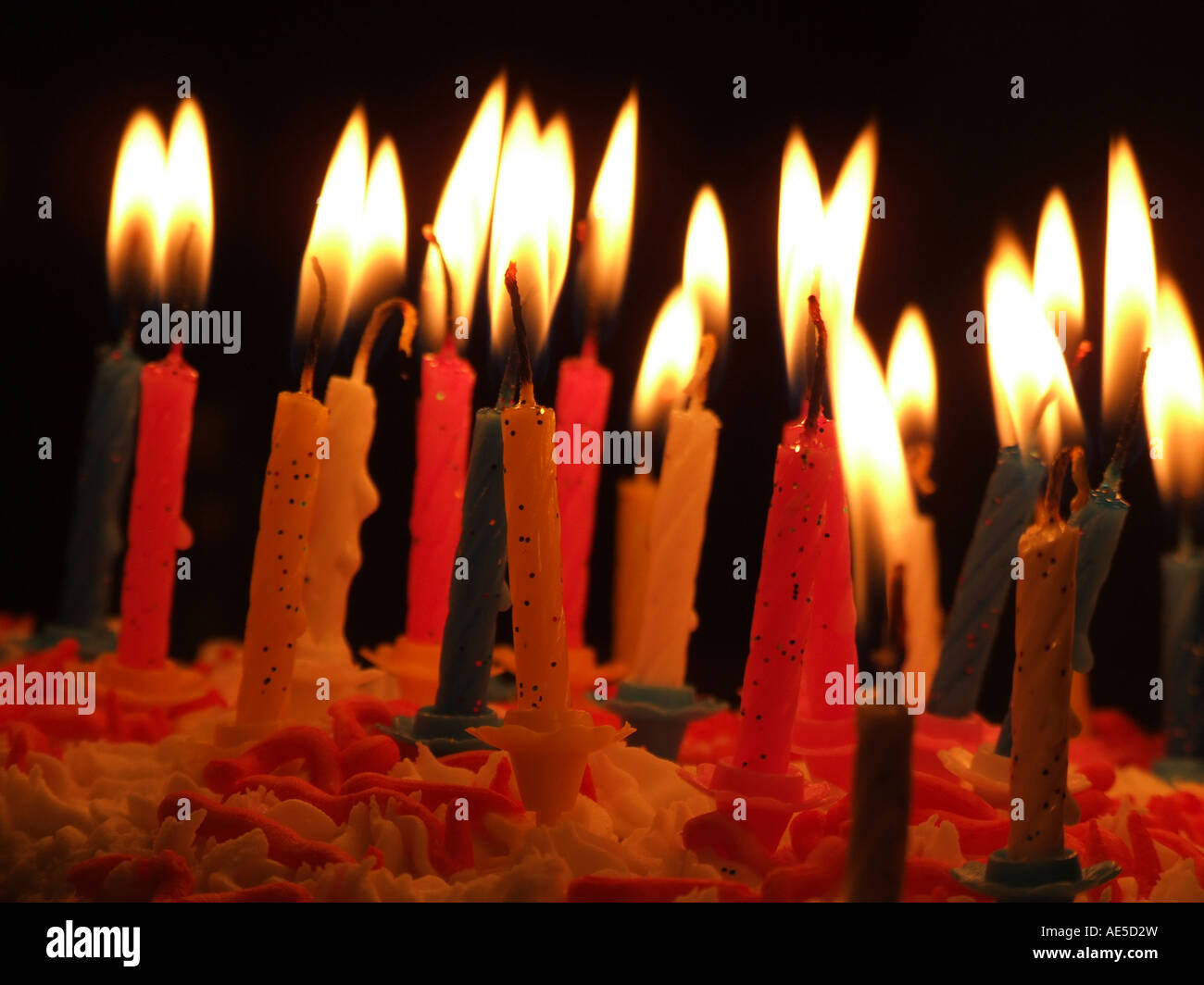 Candles on a birthday cake with a black background Stock Photo