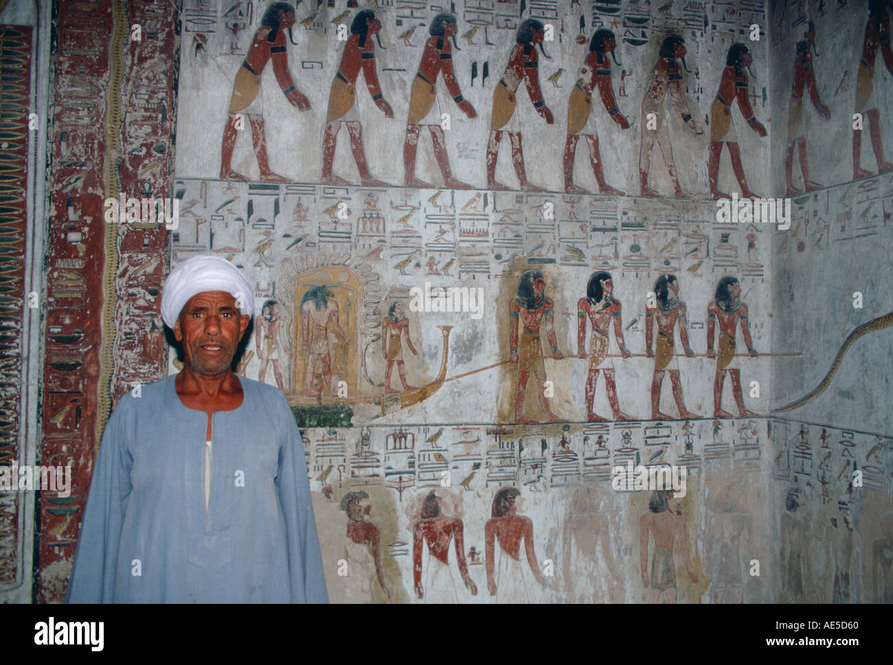 Egyptian man standing guard in King Seti's tomb in the Valley of the