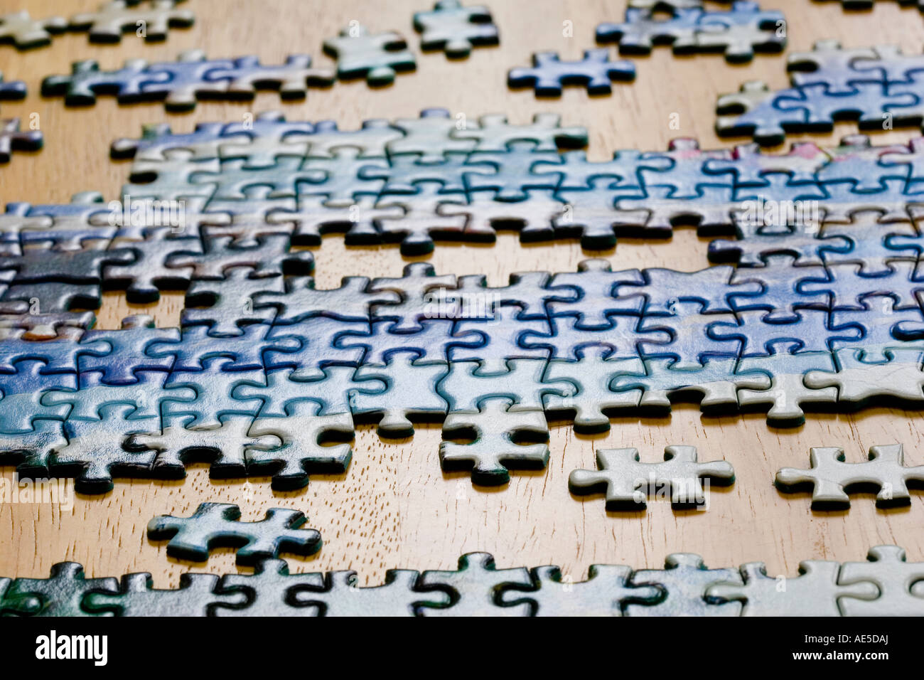 Pieces of jigsaw puzzle being put together on a table Stock Photo Alamy