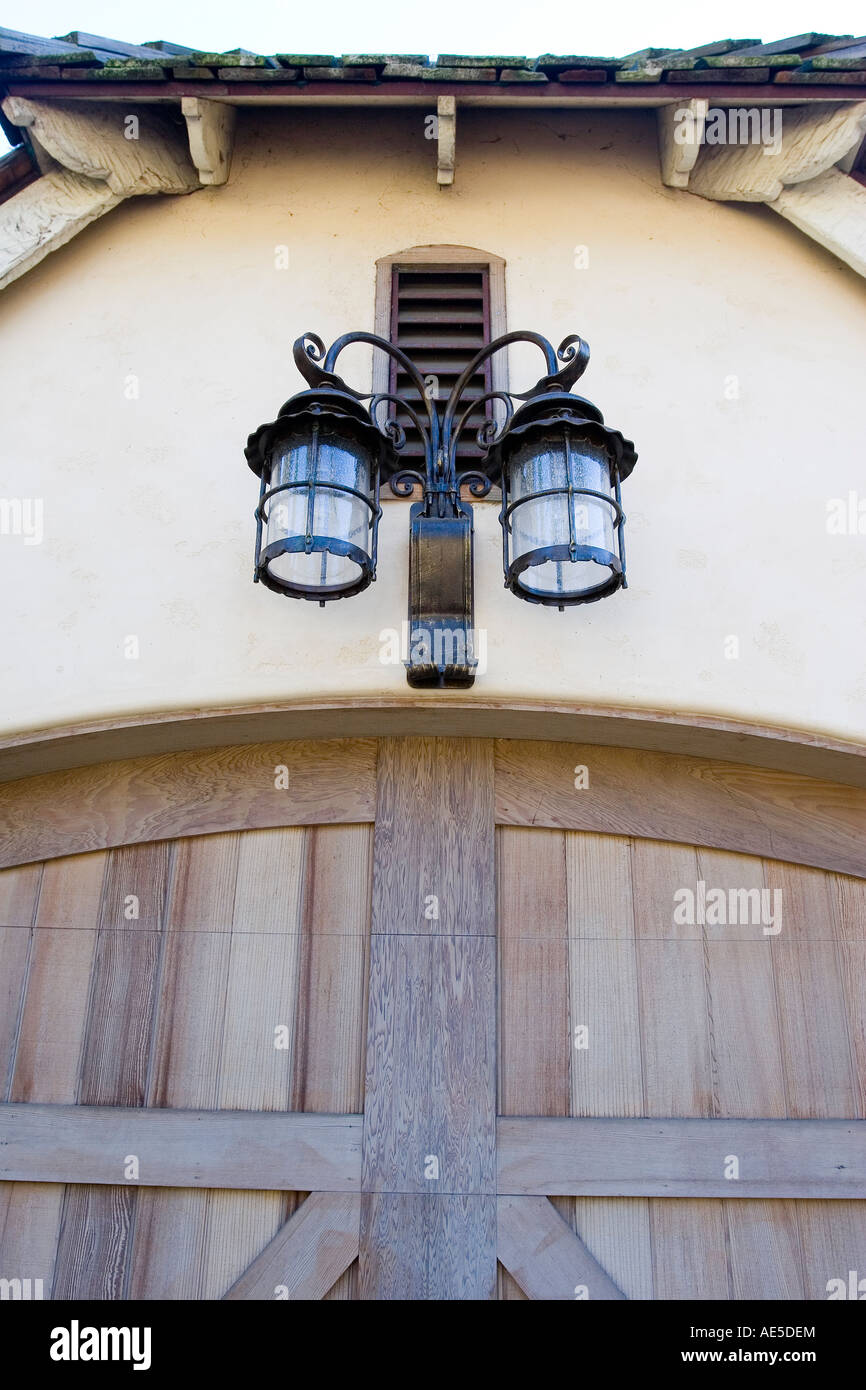 Two mission style lights of wrought iron and glass mounted over