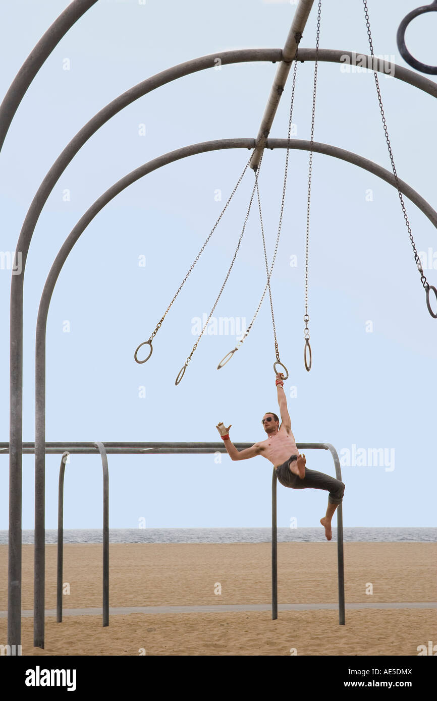 Caucasian man on the rings set swinging from one ring to the next Santa ...