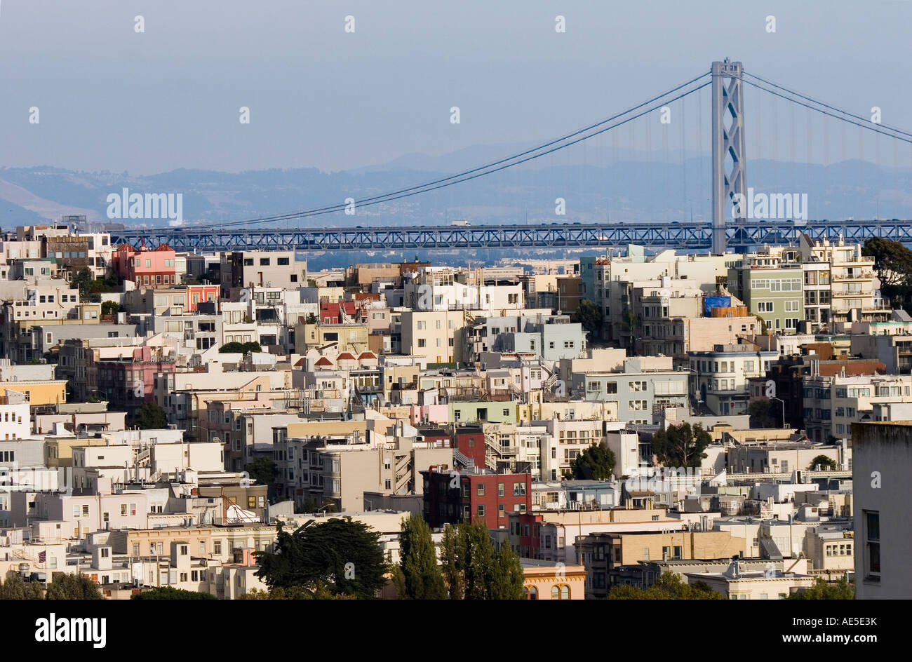San Francisco Oakland Bay Bridge above pastel colored houses in the