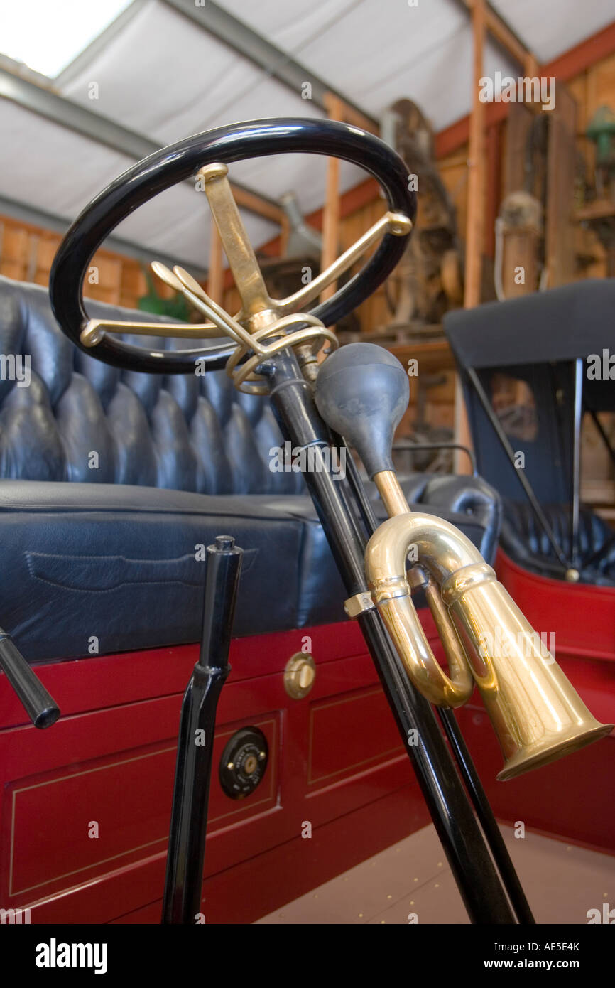 1913 International Harvester Company IHC antique car with closeup of the brass horn attached to shaft of steering wheel Stock Photo