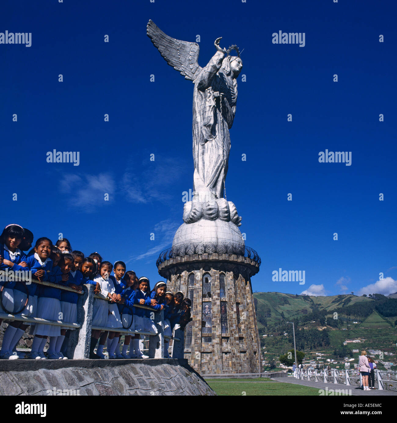 Statue of La Virgen de Quito at El Panecillo Hill with lineup of young school children at railings Quito Pichincha Ecuador Stock Photo