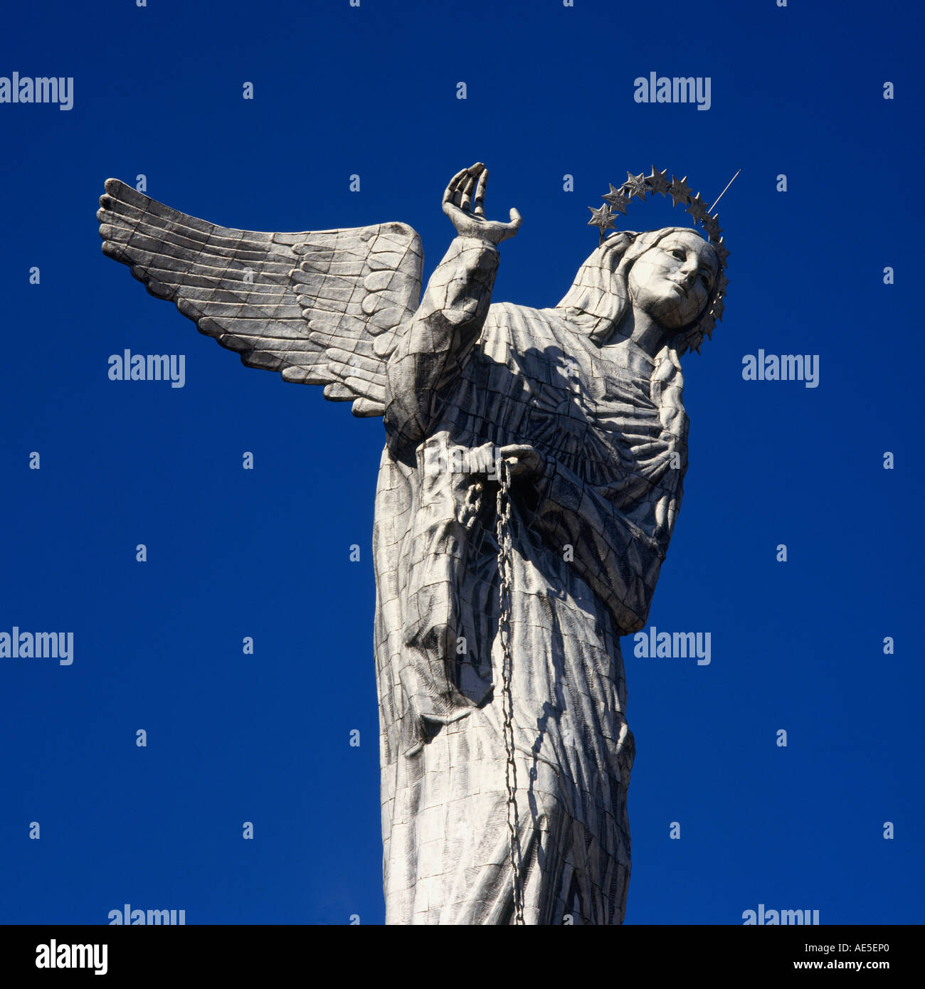 Looking up at the bright metal statue of La Virgen de Quito against a cloudless blue sky at El Panecillo Quito Pichincha Ecuador Stock Photo