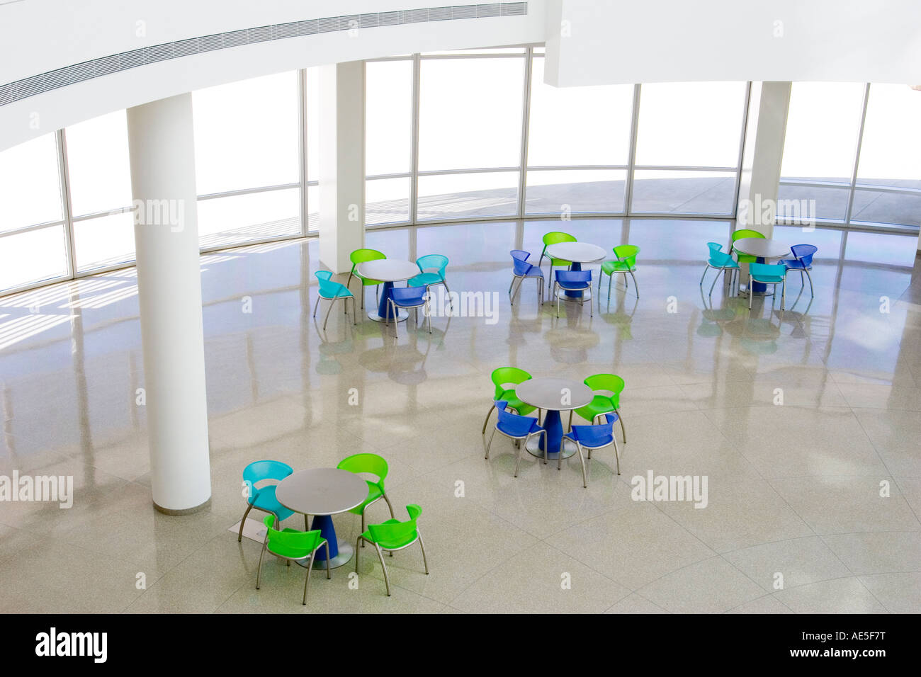 Aerial view of colorful tables and chairs at bottom floor of the San Jose City Hall rotunda building in Silicon Valley Stock Photo