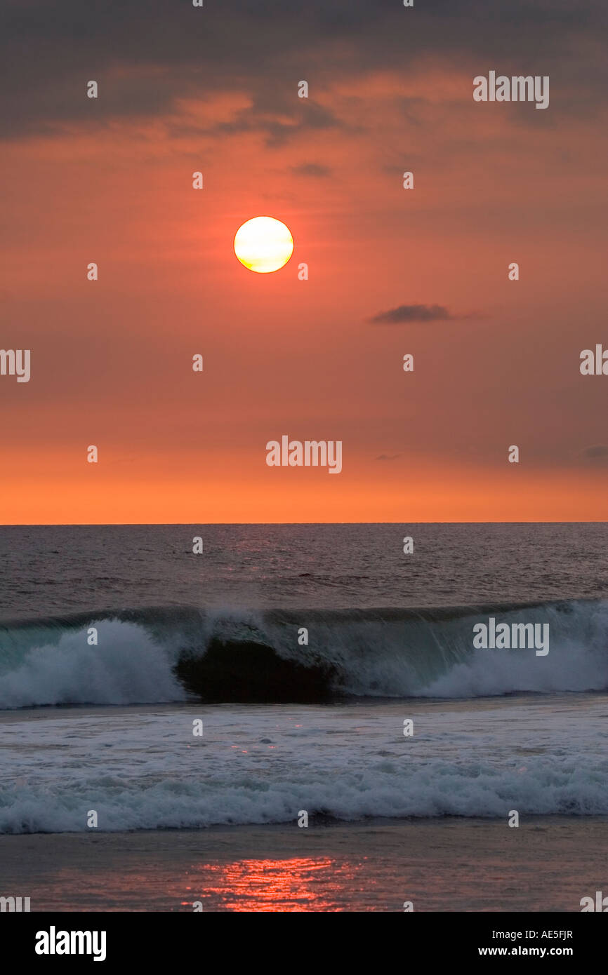 Waves crash on beach sunset hi-res stock photography and images - Alamy