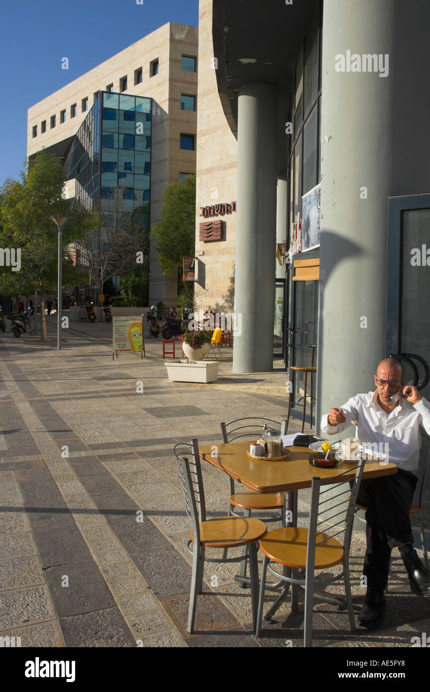 Israel Jerusalem givat shaul neighbourhood industrial estate modern buildings with man seating at cafe terrace in frgd Stock Photo