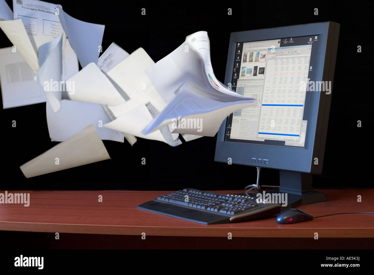 Papers being sucked into a flat screen computer monitor indicates