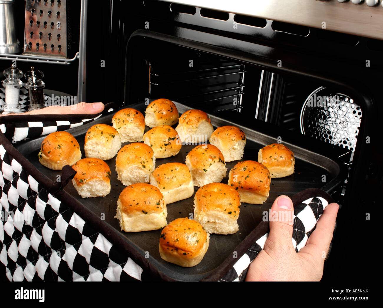 MAN BAKING GARLIC DOUGH BALLS Stock Photo