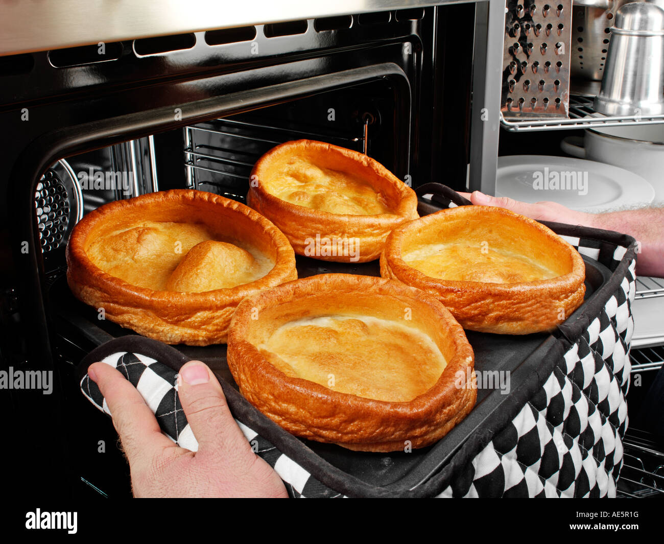 MAN COOKING GIANT YORKSHIRE PUDDINGS Stock Photo Alamy