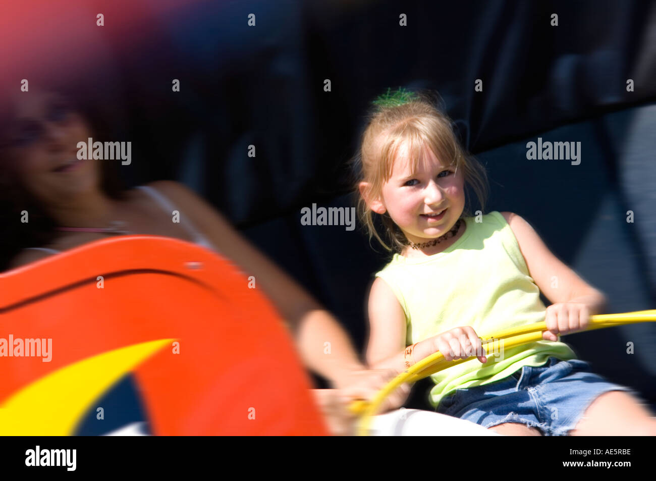Mother and daughter on carnival ride Stock Photo - Alamy