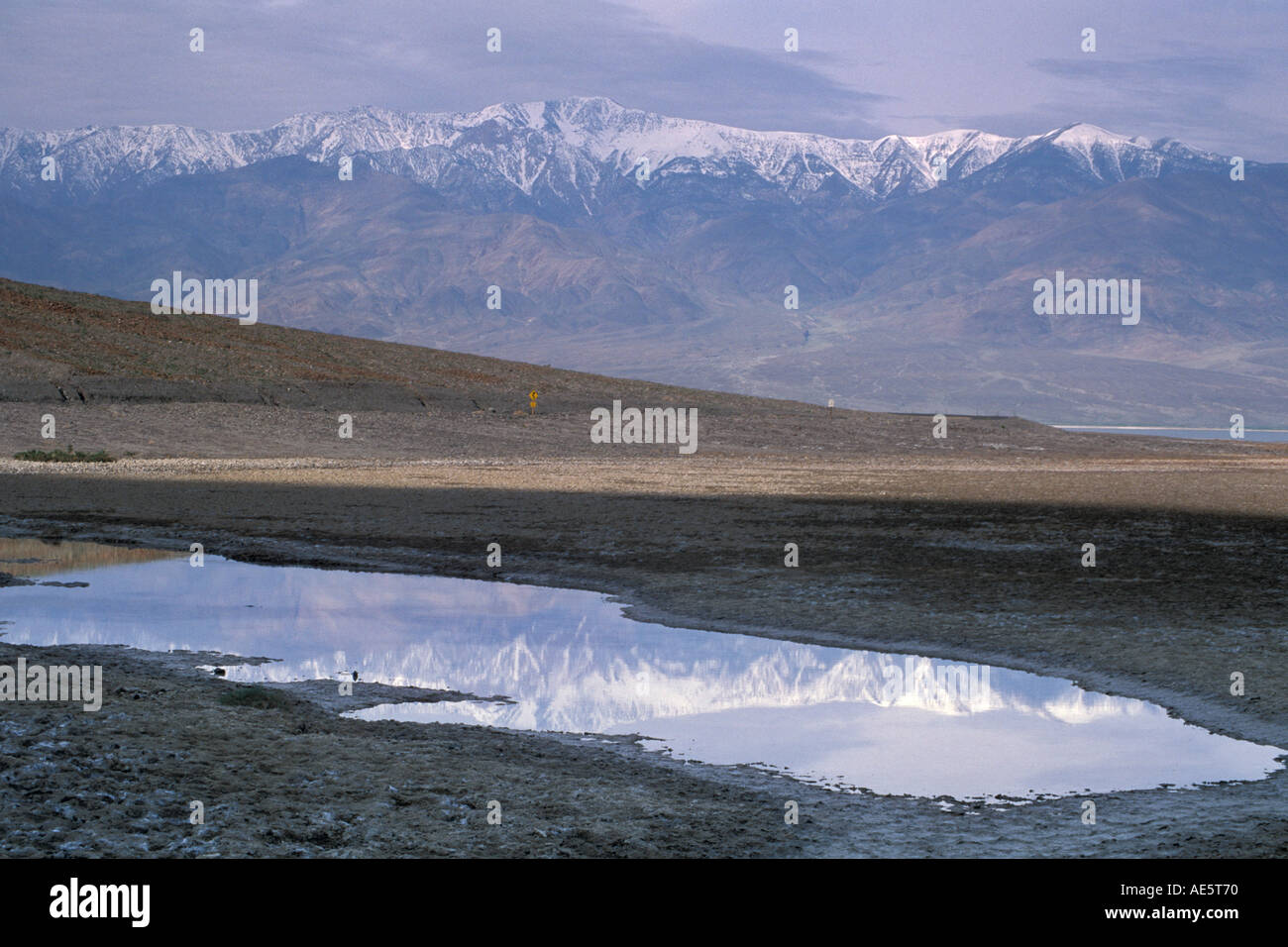 Storm clouds over Panamint Mountains and flood waters at sunrise near Badwater Death Valley California Stock Photo