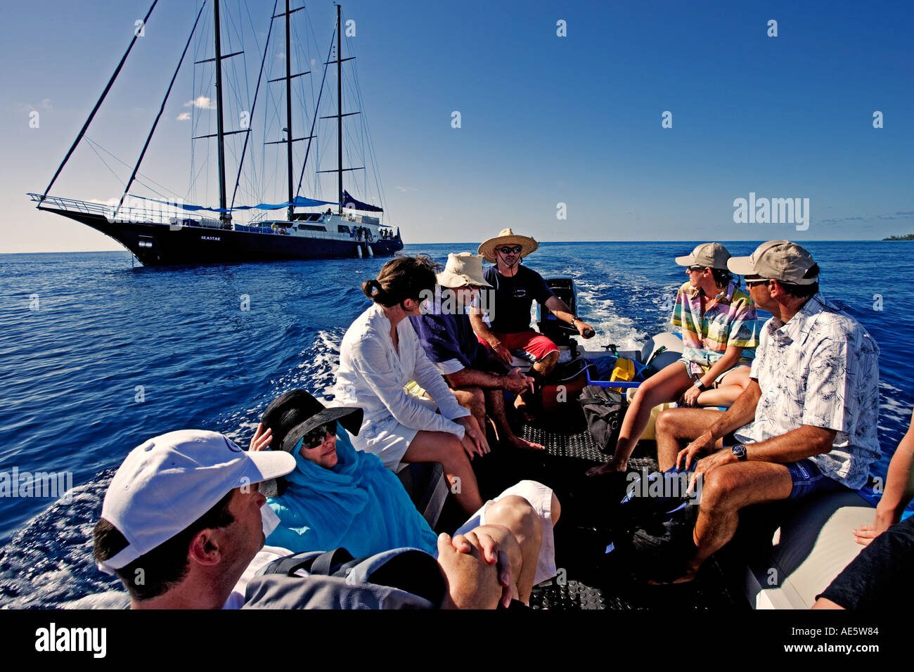 Tourists going on sight seeing expedition Sea Star Sailing Yacht Property released in background Seychelles Stock Photo
