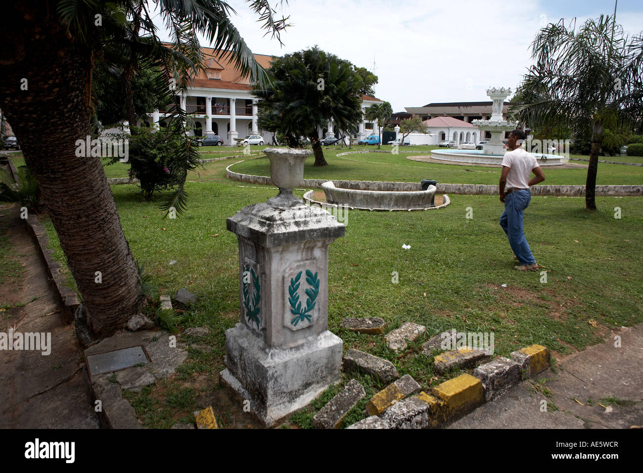 Man dashes across the grass of Place Leopold Heder towards the Conseil