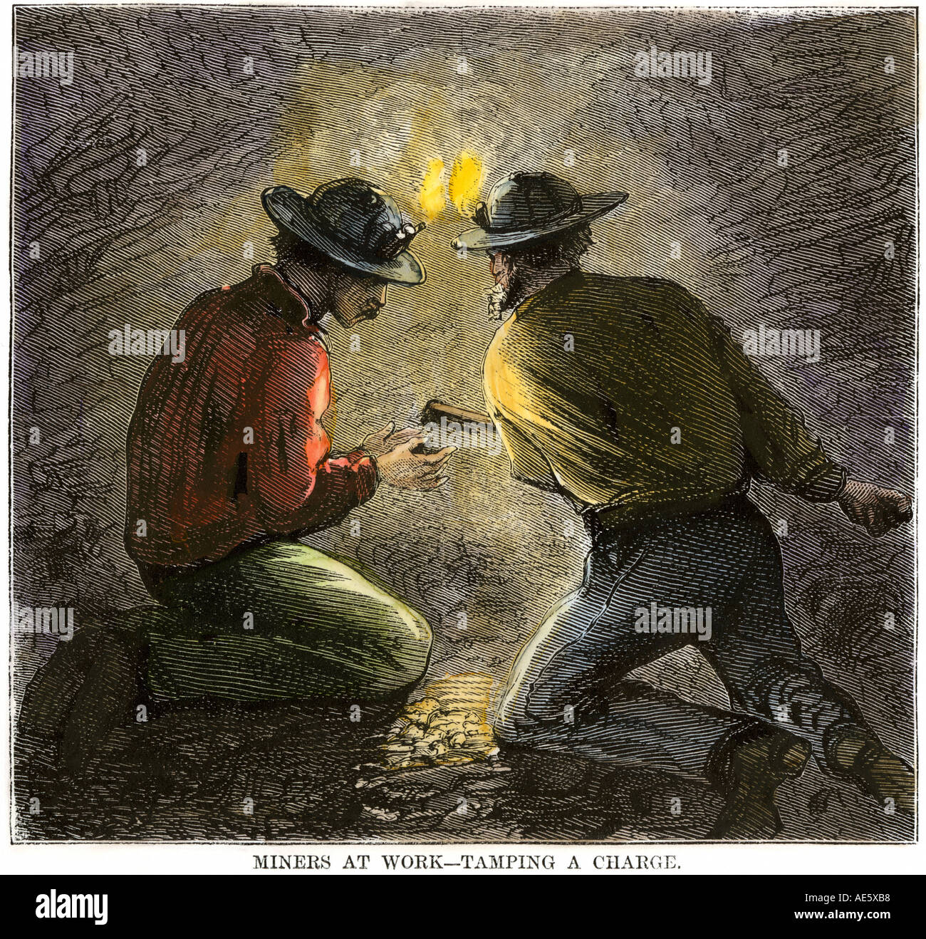 Coal miners tamping an explosive charge in a tunnel 1860s. Hand-colored woodcut Stock Photo