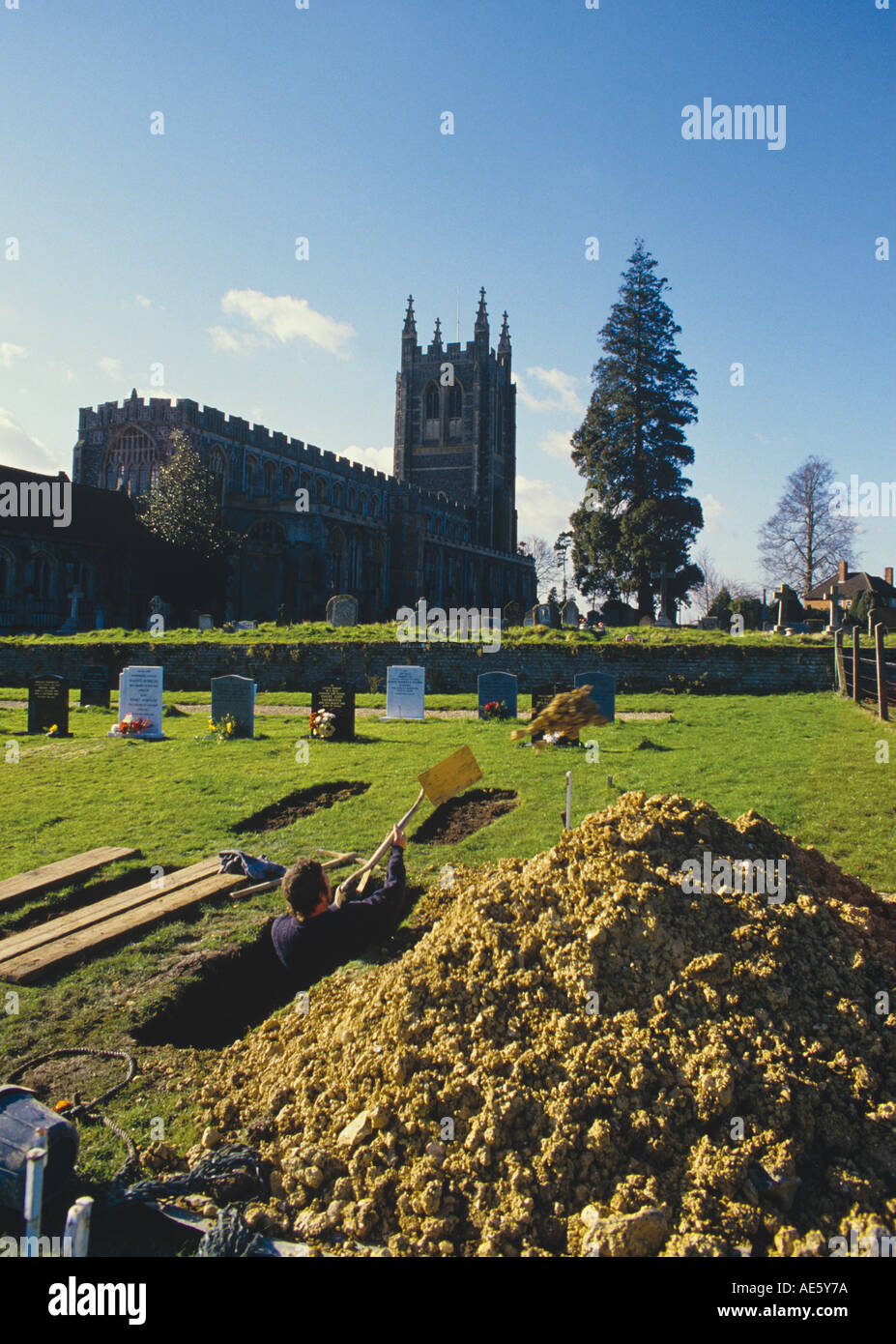 New Grave being dug in the churchyard of The Church of The Holy Trinity Long Melford Suffolk Stock Photo