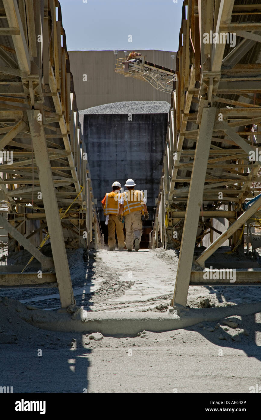 WORKERS wear HARD HATS near CONVEYER BELTS at the GRANITEROCK QUARRY