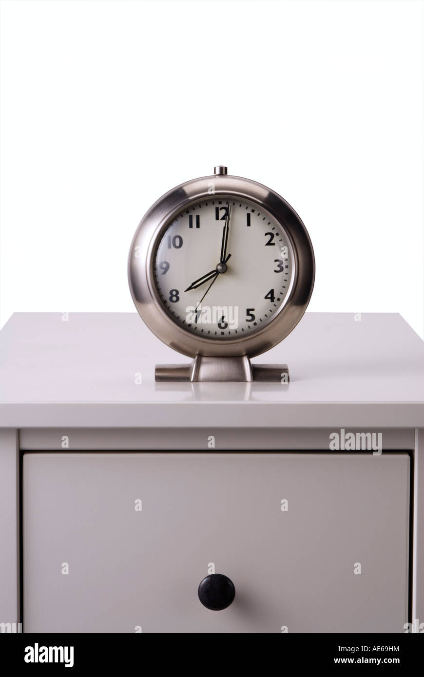 clock on bedside table on white background Stock Photo Alamy