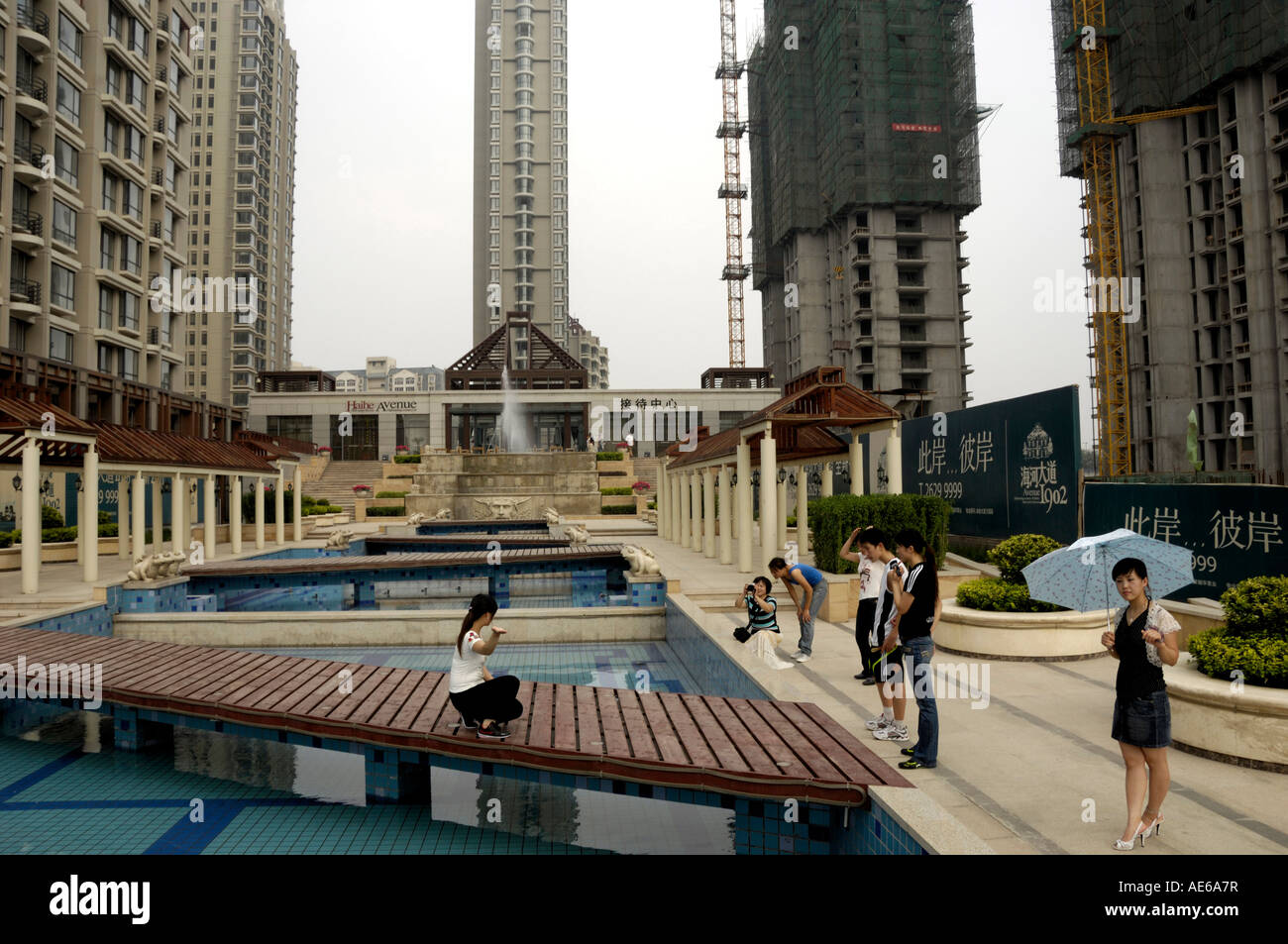 People take photos in a construction site of a luxurious apartments in Tianjin China 18-Aug-2007 Stock Photo