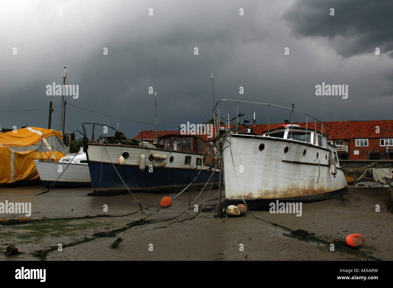 Boats stuck in mud on a low tide Stock Photo