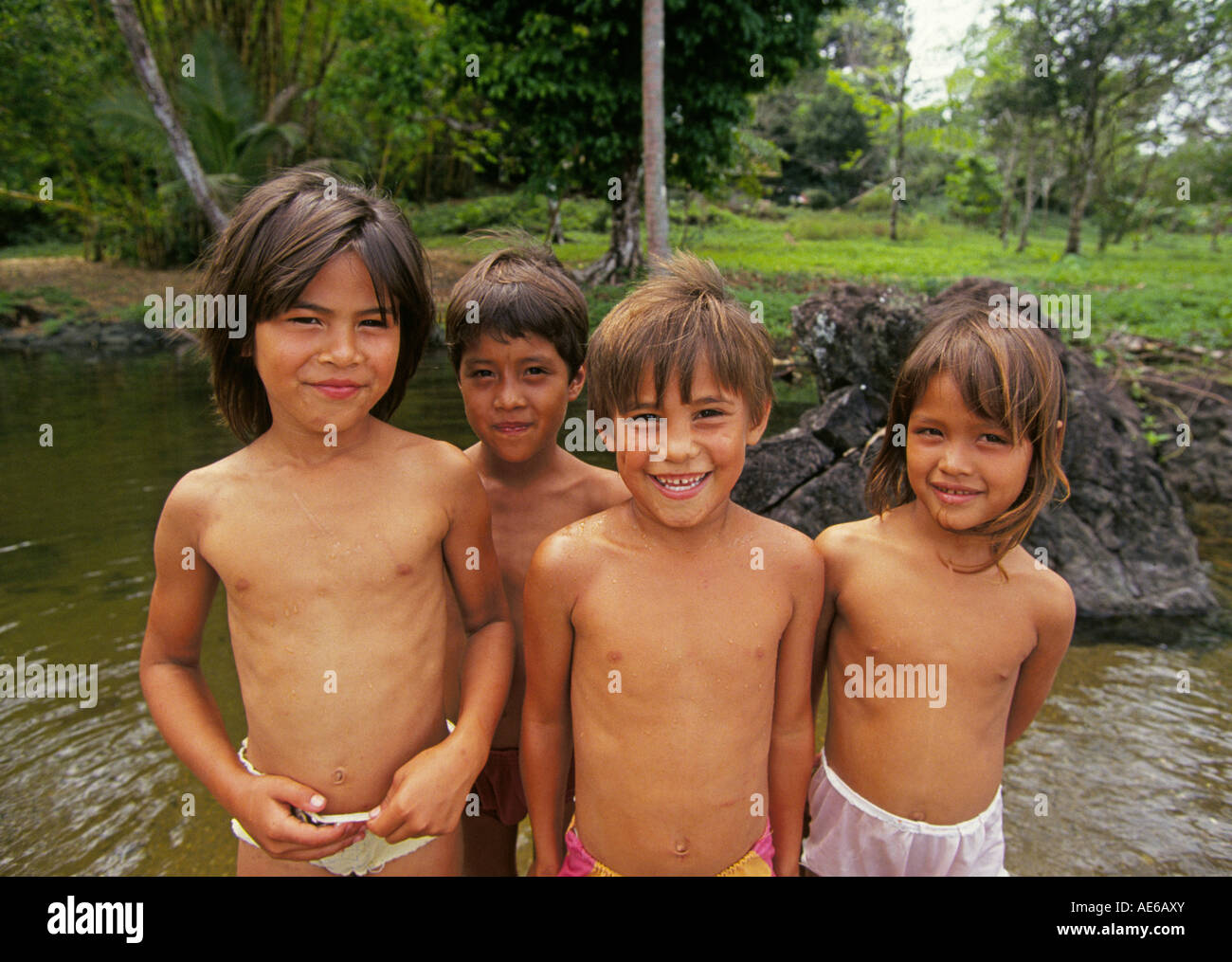 A group of rain forest Indian children swim in a shallow pool near