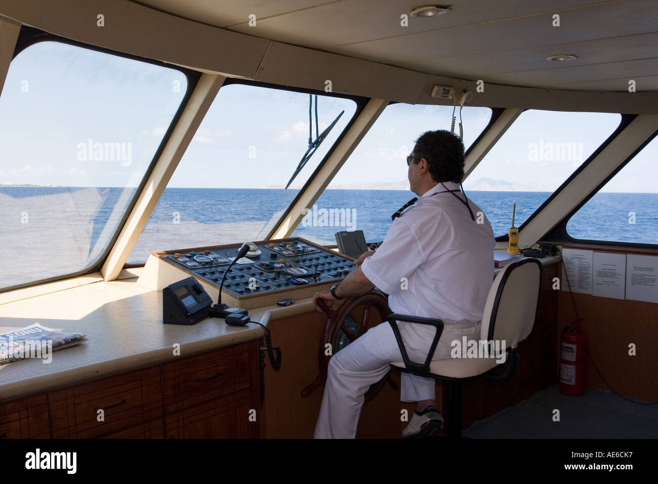 Captain on the bridge, sailing between Turkey and Greece Stock Photo