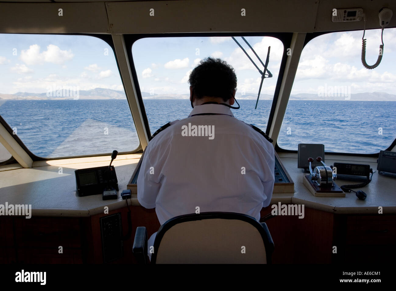Captain on the bridge, sailing between Turkey and Greece Stock Photo