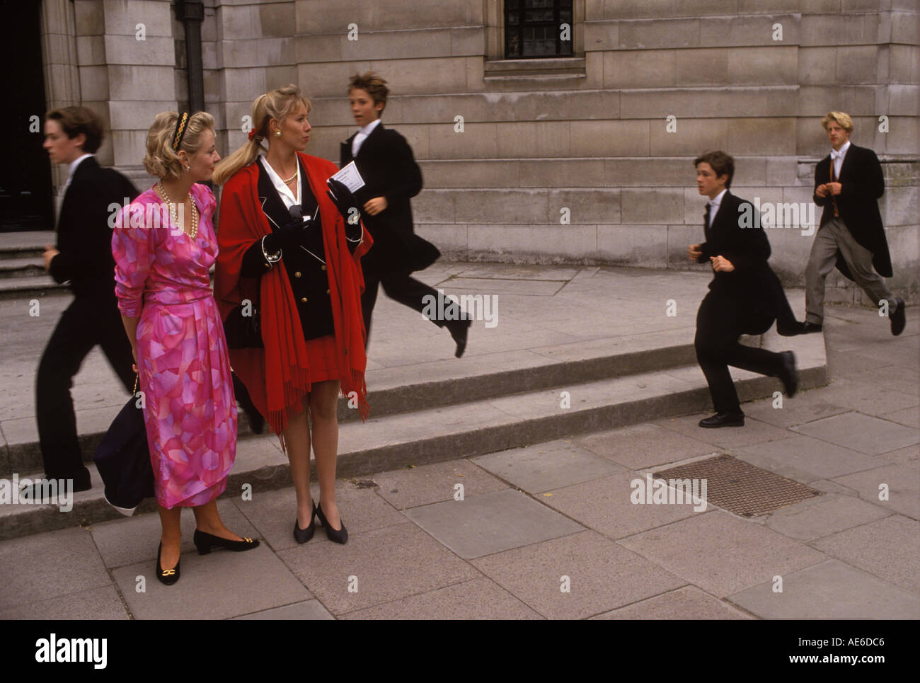 1980s women's fashion, fashionable parent dressed in red wait for their sons parents day Eton school 1985 UK. Student Jo Johnson  brother of Boris Stock Photo