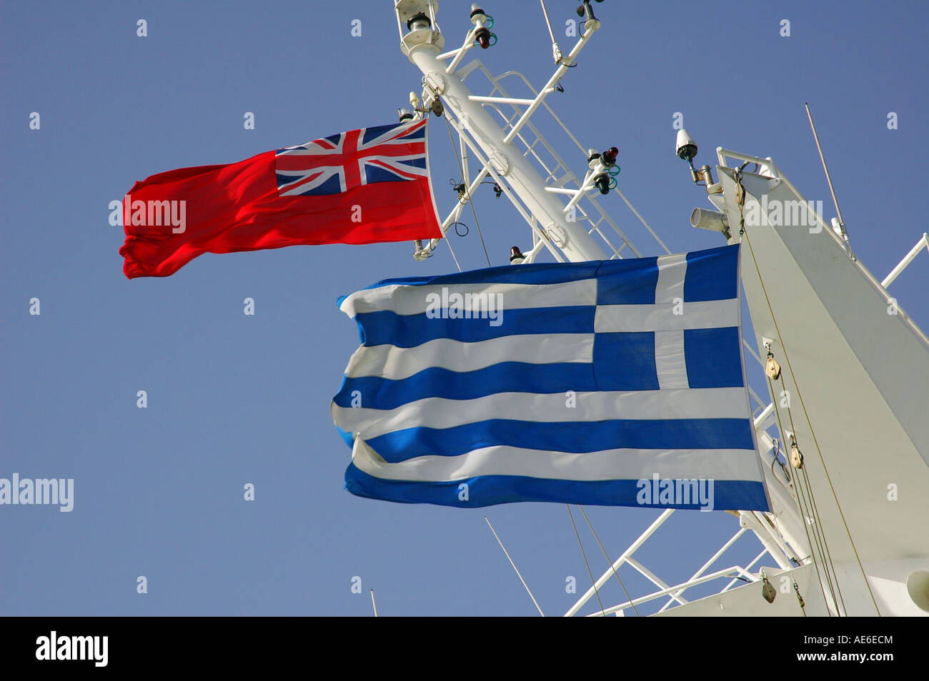 British merchant Red Ensign flag and Greek flags flying side by side on a cruise ship Stock Photo